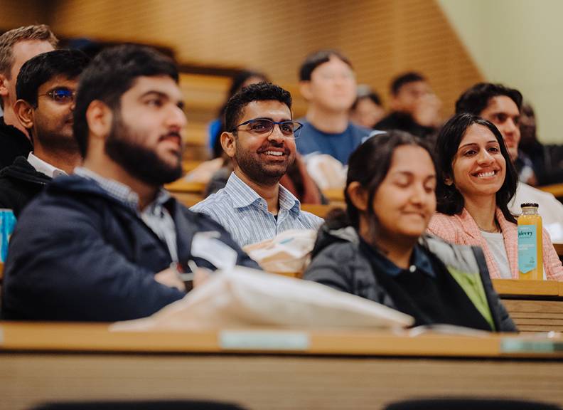 Students and professionals meeting around a table