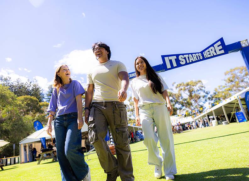 Three students walking together at an open day