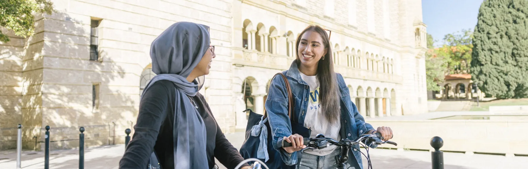 Students arriving on campus near a university building