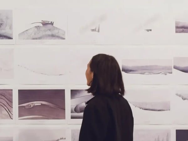 Student a wall displaying numerous designs in a themed series