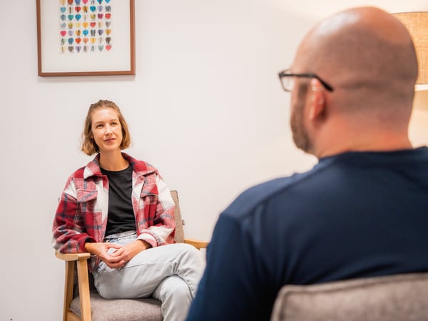 Two people in discussion seated in a casual office setting